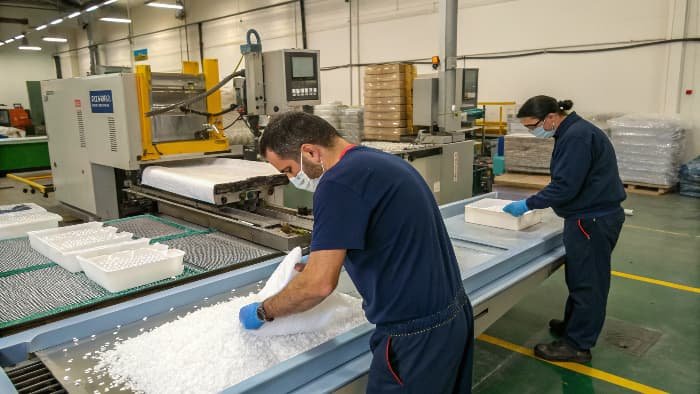 PMMA pellets being fed into an injection molding machine