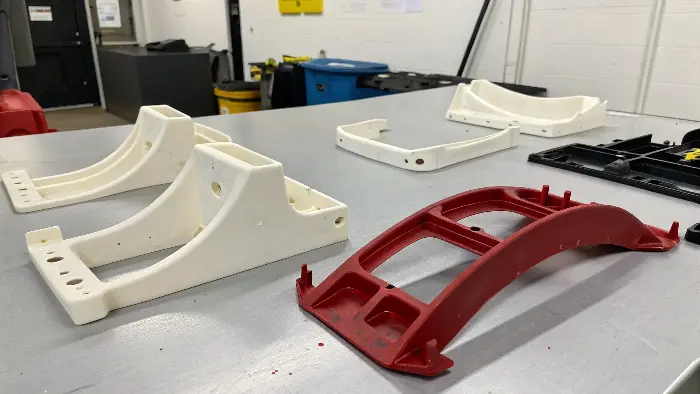 A warped plastic part next to a perfect one