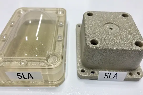 A side-by-side comparison showing the smooth surface of an SLA part and the grainy surface of an SLS part